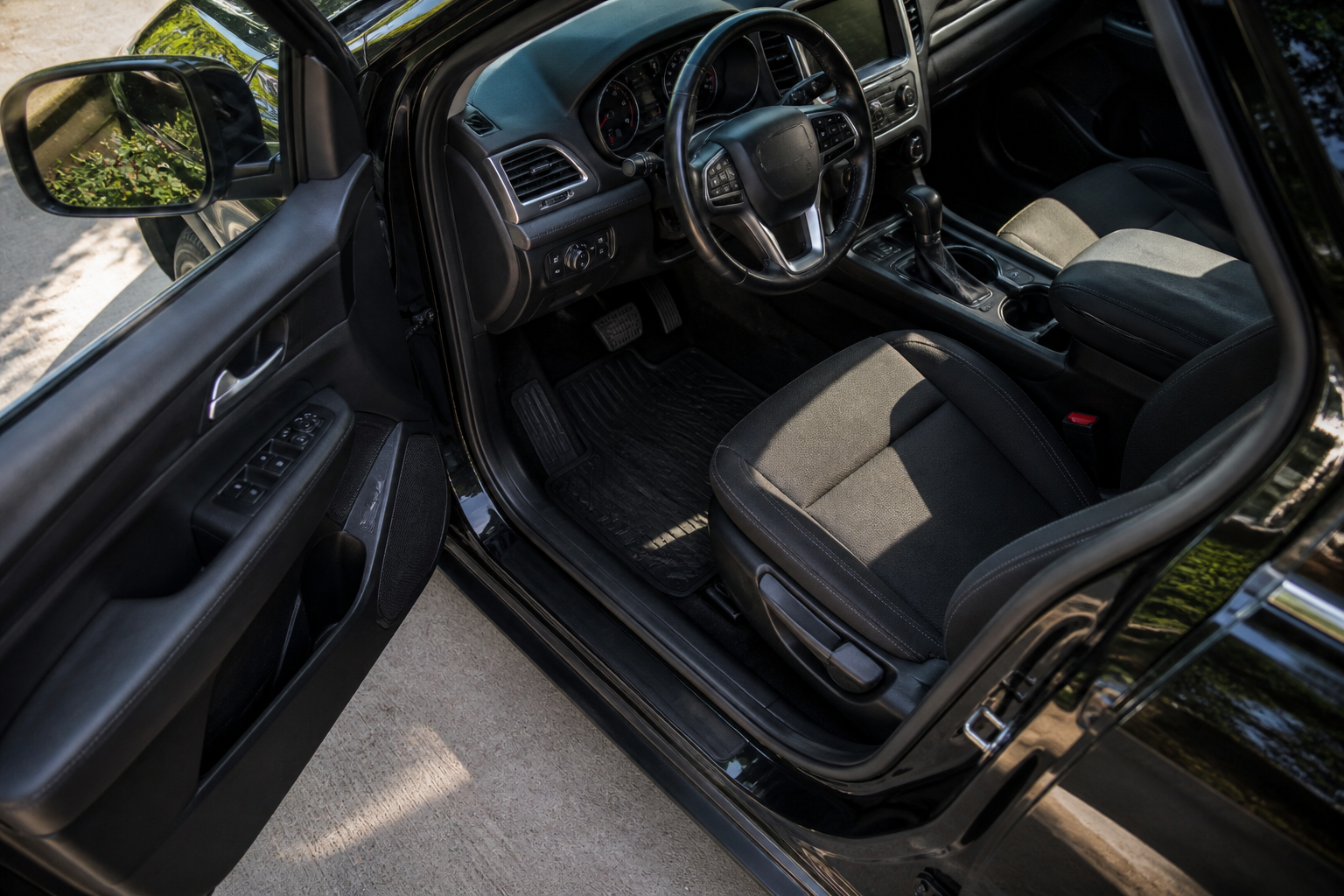 can you conceal carry in a car without a holster vehicle interior with driver door open showing seat and center console area