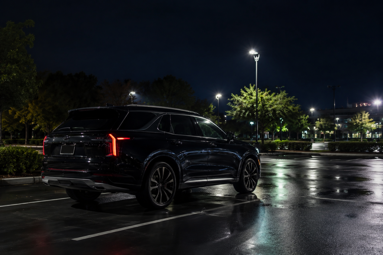 can you carry a loaded gun in your car modern suv parked under streetlights at night with reflections on wet pavement in quiet parking lot