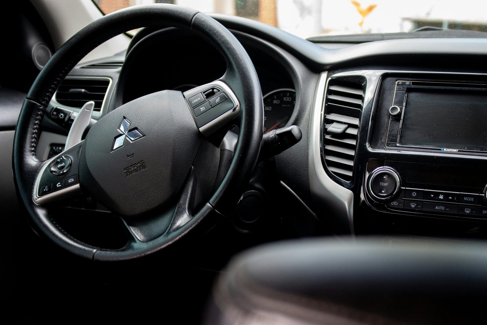 vehicle holster in a rental car showing the steering wheel, dashboard, and interior of a temporary travel vehicle